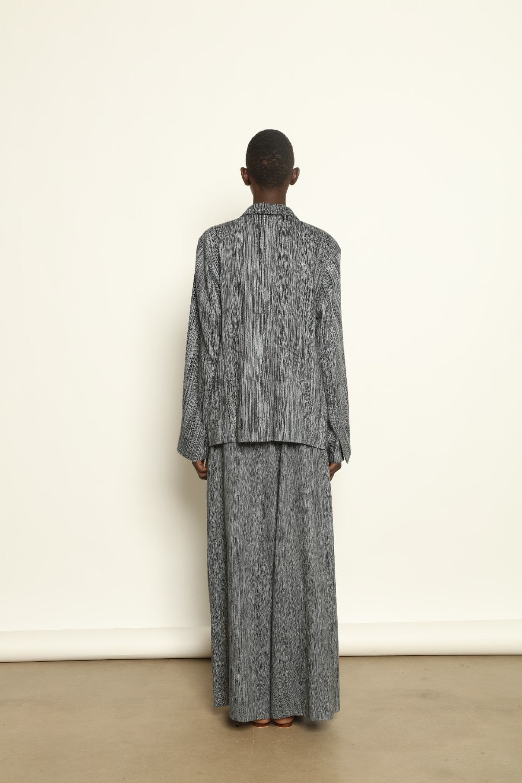 Model is wearing the Grey Chambray Blazer by Marrakshi Life, part of House of Nomad Stories collection, handwoven cotton blazer with relaxed fit, notched collar, and classic tailored details