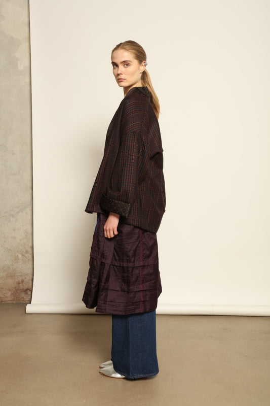 Model is wearing the Harmony Kantha Jacket by Obidi, made from reused sari fabric with traditional kantha hand-stitching, combining heritage craftsmanship with a contemporary silhouette.