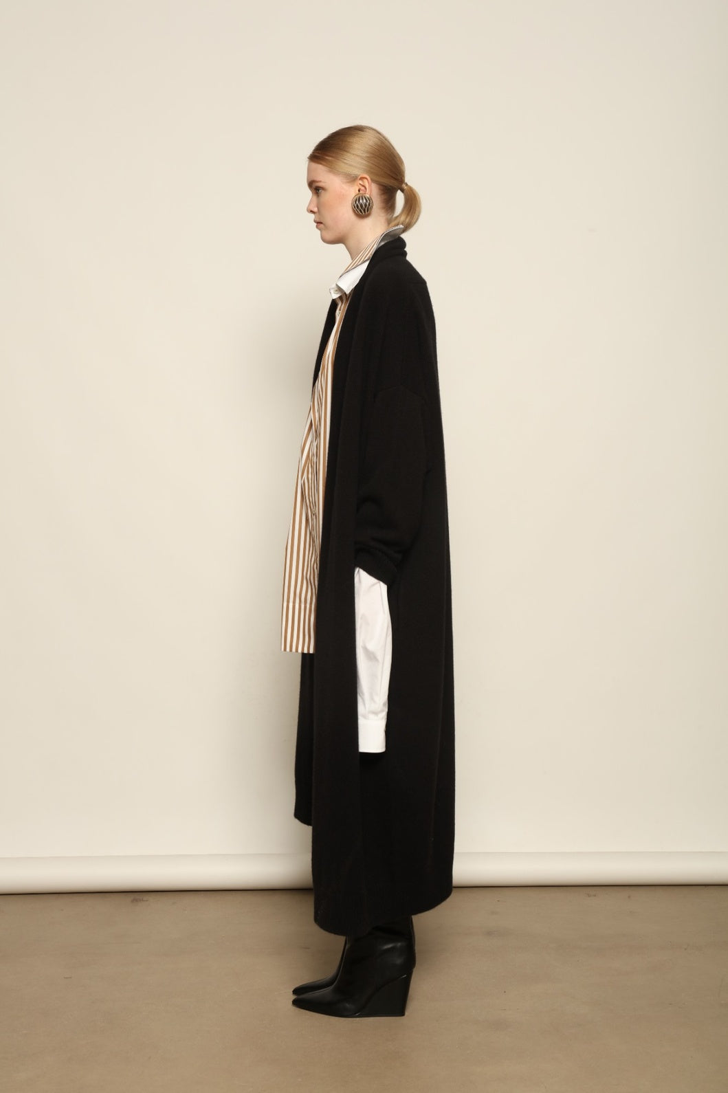 Model is wearing the Black Paula Cashmere Coat by House of Woven Stories, a pure ethically sourced cashmere coat in deep black with fluid open-front silhouette and refined drape.