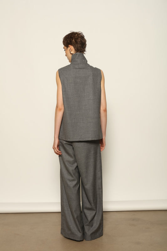 Model wearing the Franca Grey Off White Gilet by House of Woven Stories, featuring a tailored structured silhouette, clean minimalist design, and refined layered styling in a grey off-white tone.
