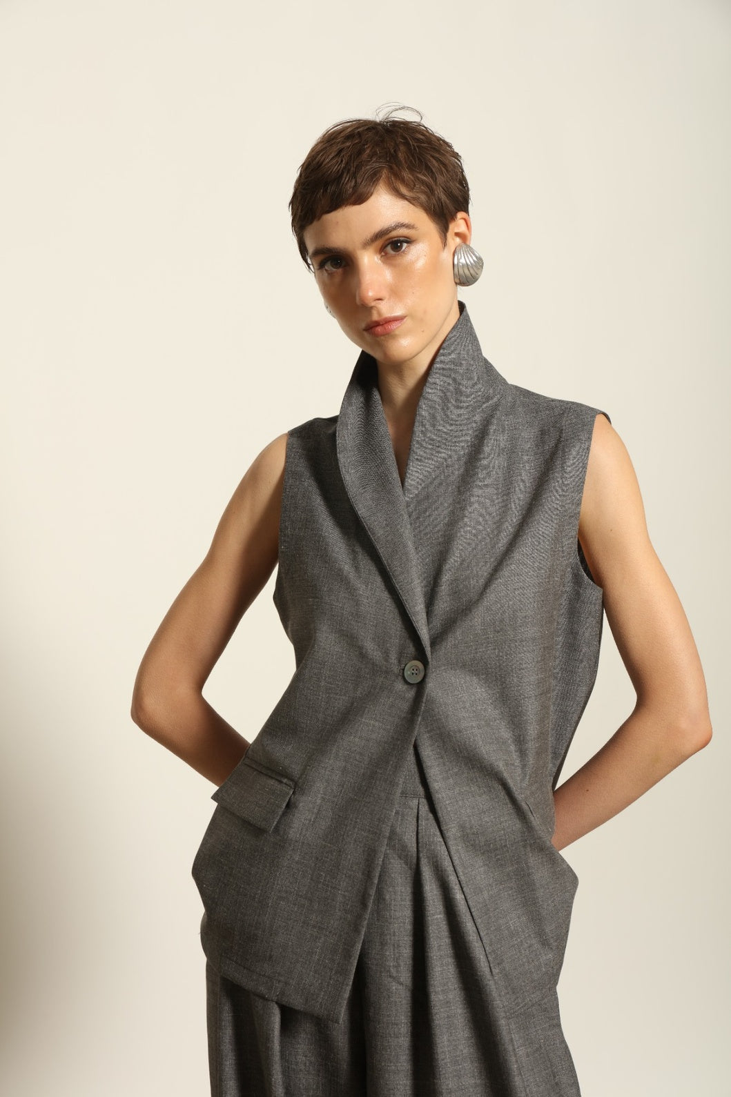 Model wearing the Franca Grey Off White Gilet by House of Woven Stories, featuring a tailored structured silhouette, clean minimalist design, and refined layered styling in a grey off-white tone.