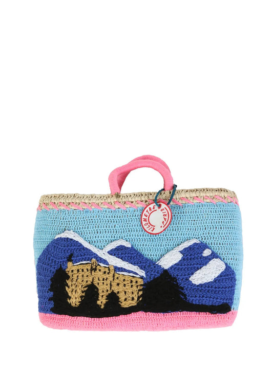 Diamond & Rolls Undercover basket bag by Kilometre Paris, curated by House of Woven Stories, featuring pink crochet, blue Gstaad lettering and vintage car embroidery on handwoven straw, inspired by winter glamour and travel
