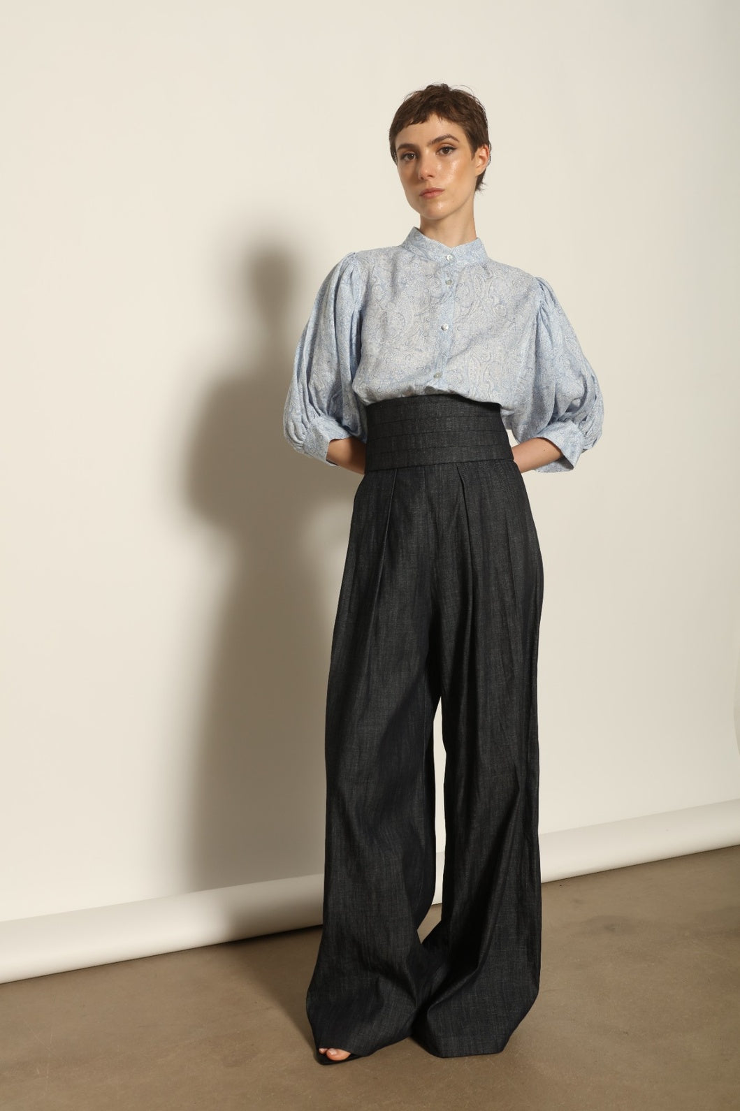 Model wearing the Sergey Night Blue Cummerbund by House of Woven Stories, featuring a structured silk-wool blend, deep night blue tone, and sculptural waist-defining silhouette.