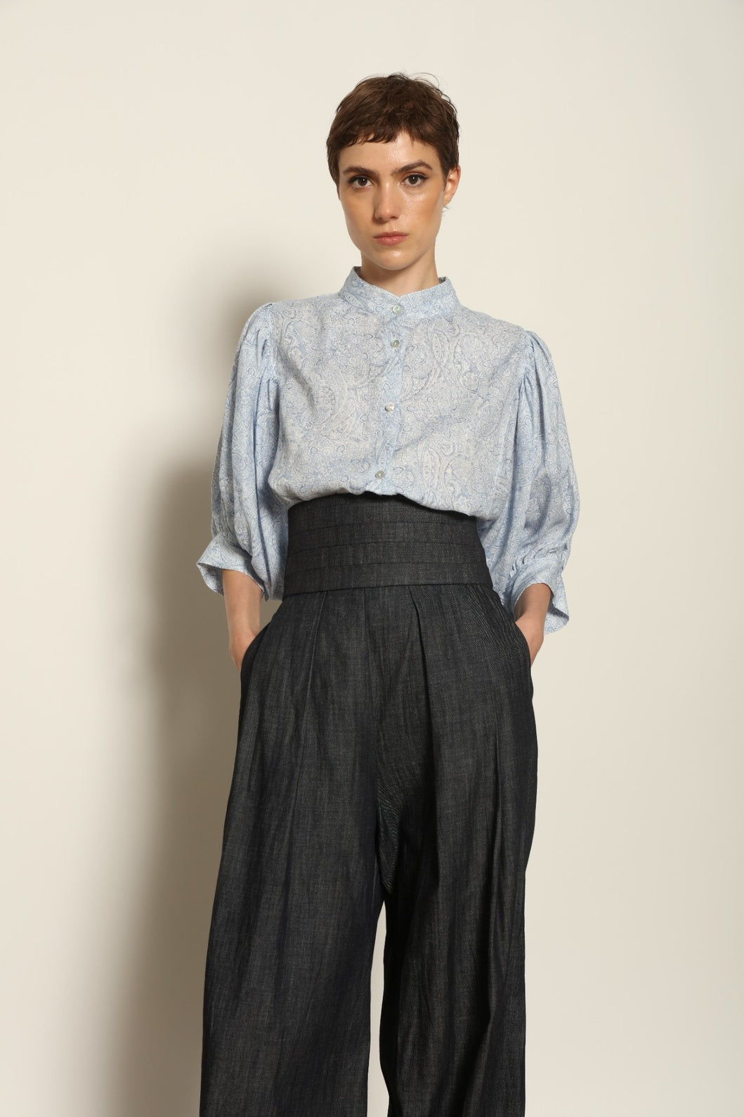 Model wearing the Sergey Night Blue Cummerbund by House of Woven Stories, featuring a structured silk-wool blend, deep night blue tone, and sculptural waist-defining silhouette.