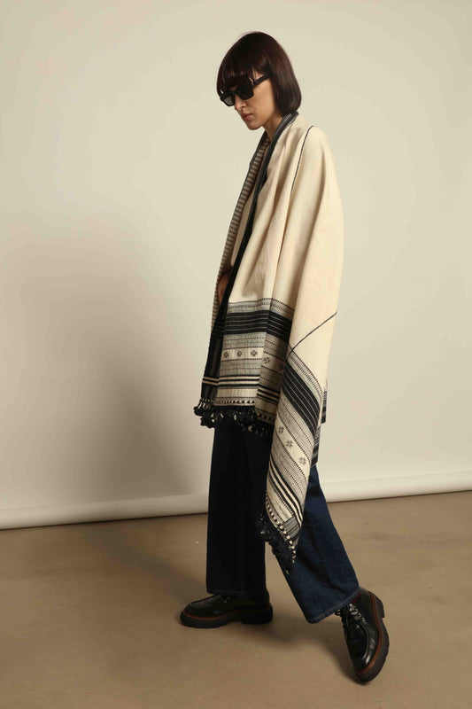 Handwoven Kala cotton throw Ananta by House of Woven Stories, crafted with handspun yarn and embroidered panels by master weaver Shamji Vankar Vishram Valji in Bhujodi, India.