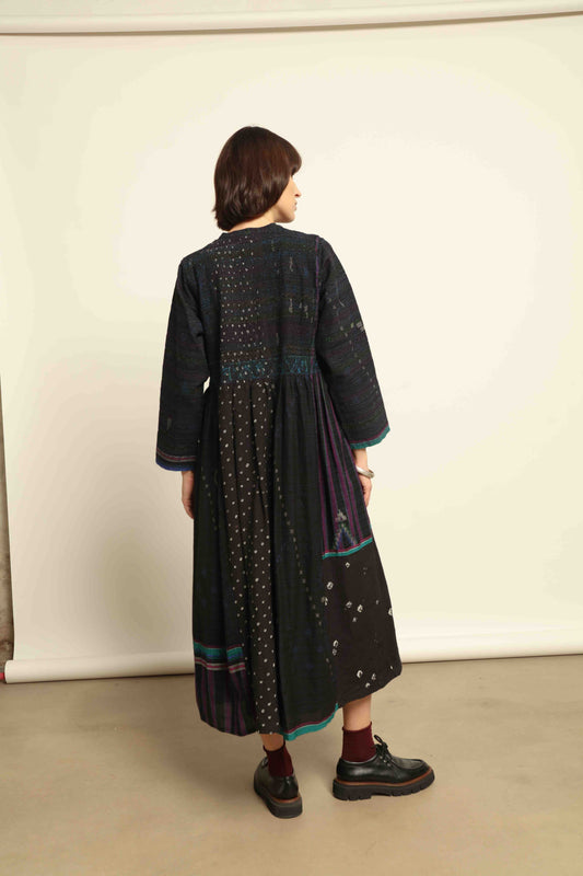 Model is wearing the Folklore 20 dress by Injiri, handmade from silk and wool using traditional Indian handloom techniques, featuring a round neckline, long sleeves, side pockets, and a flattering cut below the bust, curated by House of Woven Stories.