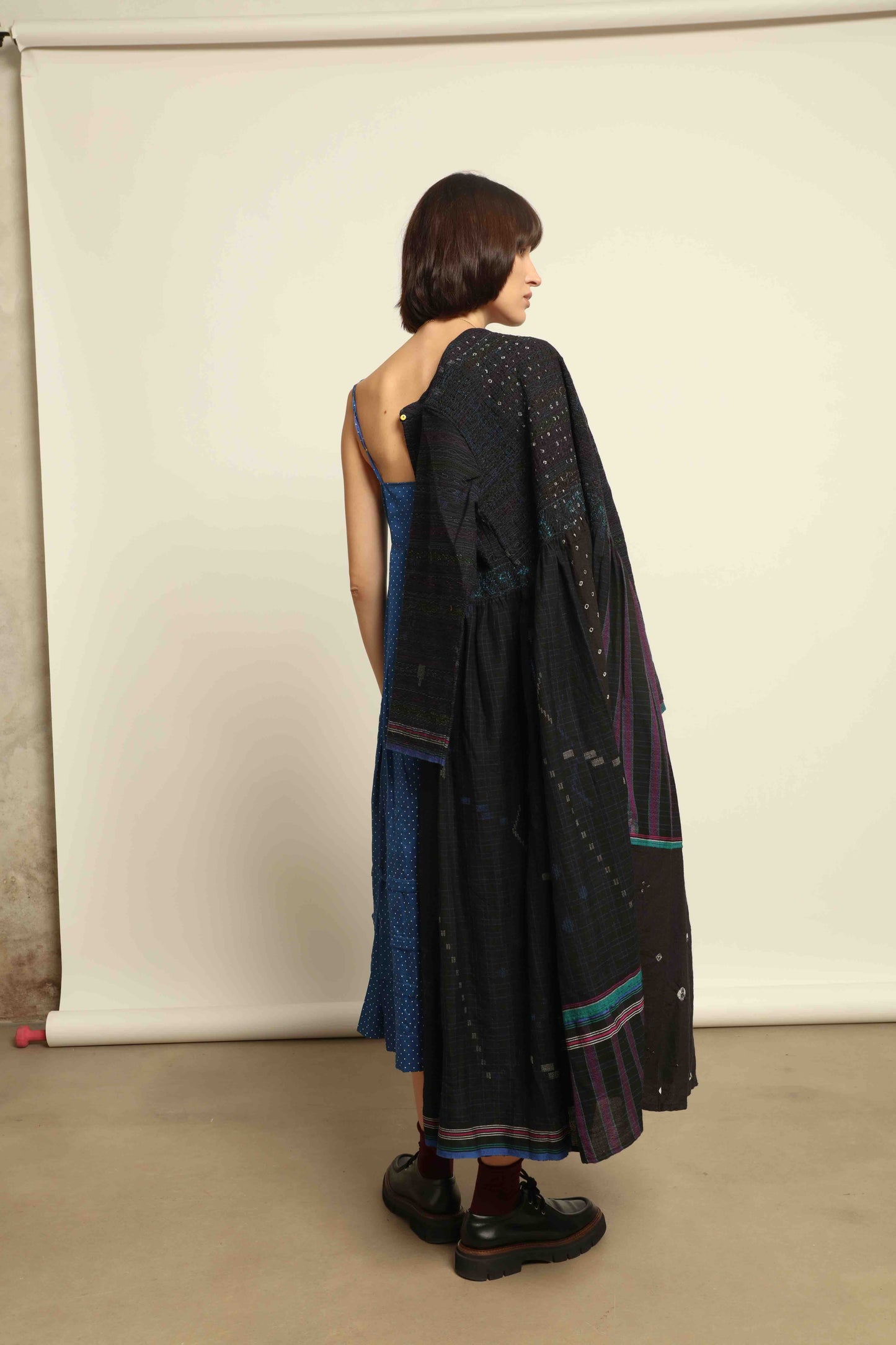 Model is wearing the Folklore 20 dress by Injiri, handmade from silk and wool using traditional Indian handloom techniques, featuring a round neckline, long sleeves, side pockets, and a flattering cut below the bust, curated by House of Woven Stories.