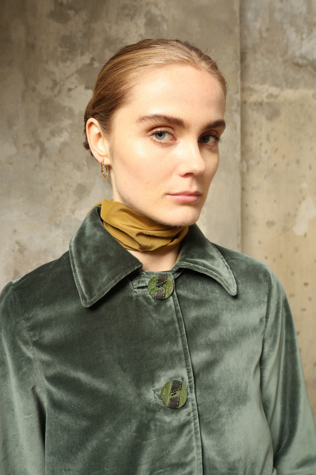 Model wearing Katharina Jacket in Velvet Green Cotton by House of Woven Stories, part of the curated selection, handcrafted in Italy from fine cotton velvet with hand-dyed shibori lining, expressing timeless elegance and artisanal craftsmanship.