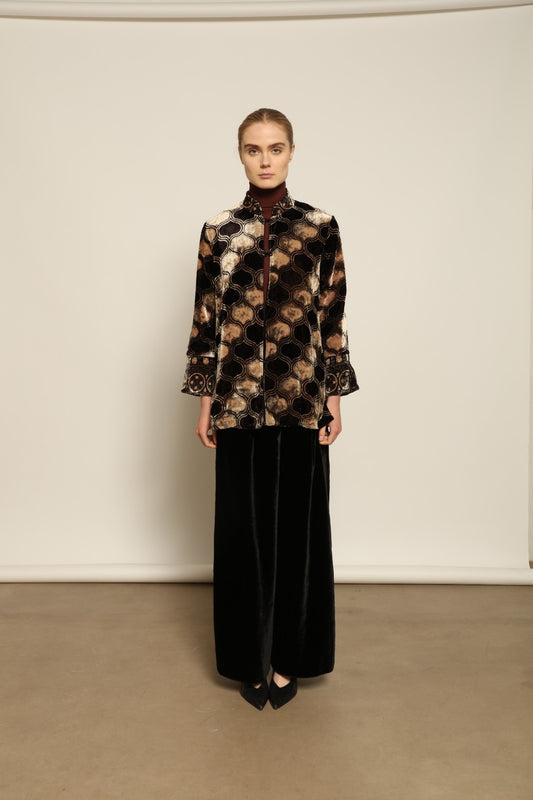 Model is wearing the Kati Black Velvet Trousers by Obidi, crafted from luxurious velvet with a tailored silhouette, combining timeless craftsmanship with modern versatile style.