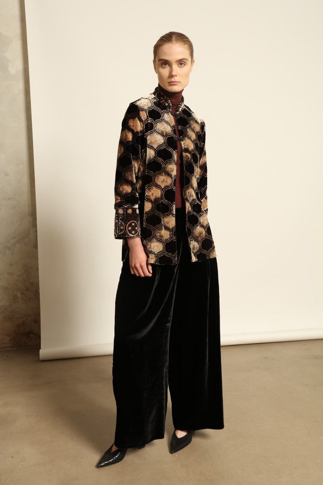 Model is wearing the Kati Black Velvet Trousers by Obidi, crafted from luxurious velvet with a tailored silhouette, combining timeless craftsmanship with modern versatile style.