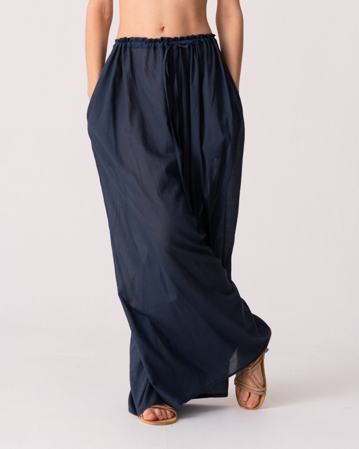Model is wearing the Liquid Navy Cotton Pantaloons by Les Vacances d’Irina, wide-leg handmade cotton voile pants with drawstring waist and side pockets, available at House of Woven Stories.