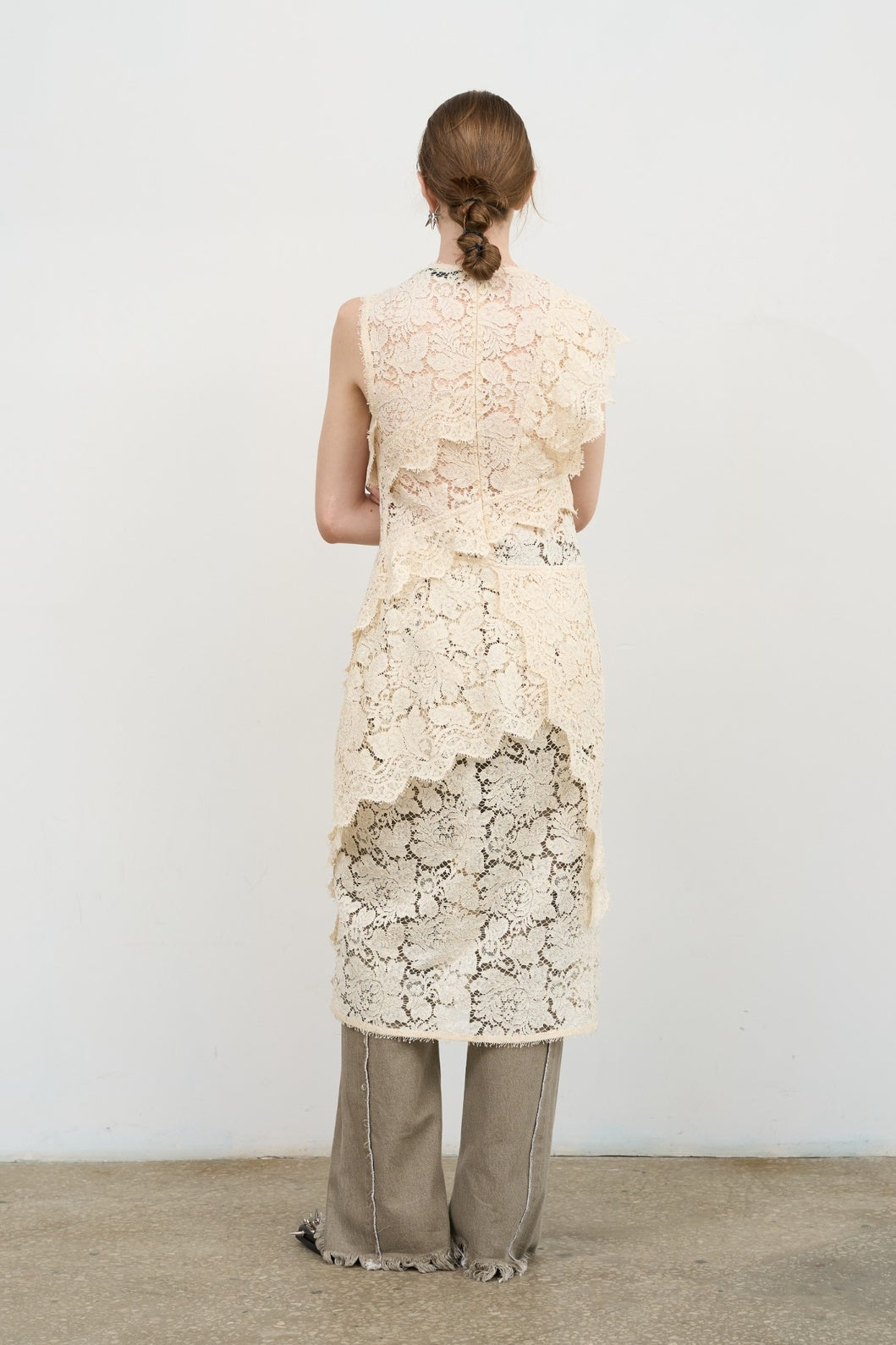 Model is wearing Litkovska ivory lace overlay midi dress with layered ruffles and high neck, a contemporary artisanal design that belongs to the curated selection of House of Nomad Stories.