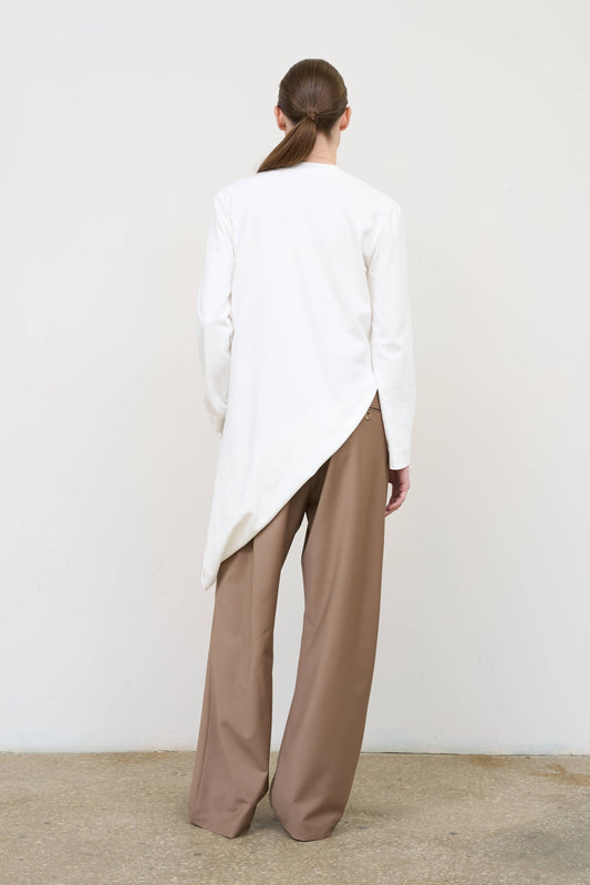 Model is wearing high-rise pleated pants by Litkovska with drawstring waist and relaxed straight leg, designer women’s trousers available at House of Woven Stories