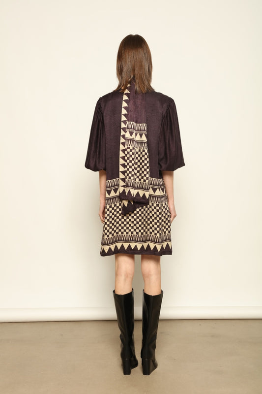 Model is wearing the Malaga Short Silk Dress with Belt by House of Woven Stories, hand-printed in Ajrakh silk with balloon sleeves and a waist belt.