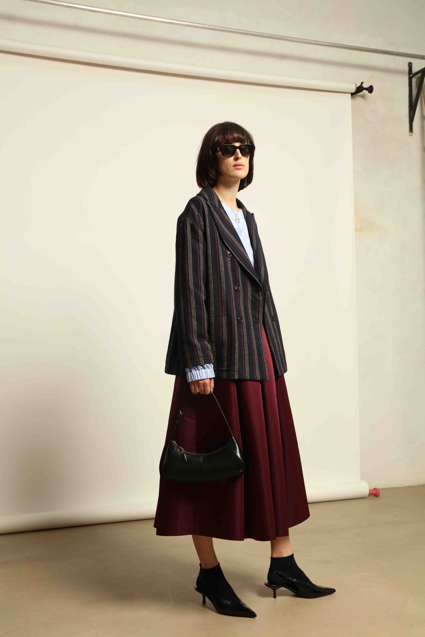 Model is wearing the Navy Blue Striped Double-Breasted Blazer by Balia 8.22, crafted in Italy from virgin wool and cotton with a structured silhouette for timeless elegance.