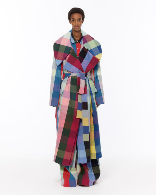 Model is wearing the Double Lapel Overcoat by Marrakshi Life, a hand-woven cotton bouclé coat with oversized plaid, sculptural double lapel and tie belt, curated in the House of Woven Stories selection.