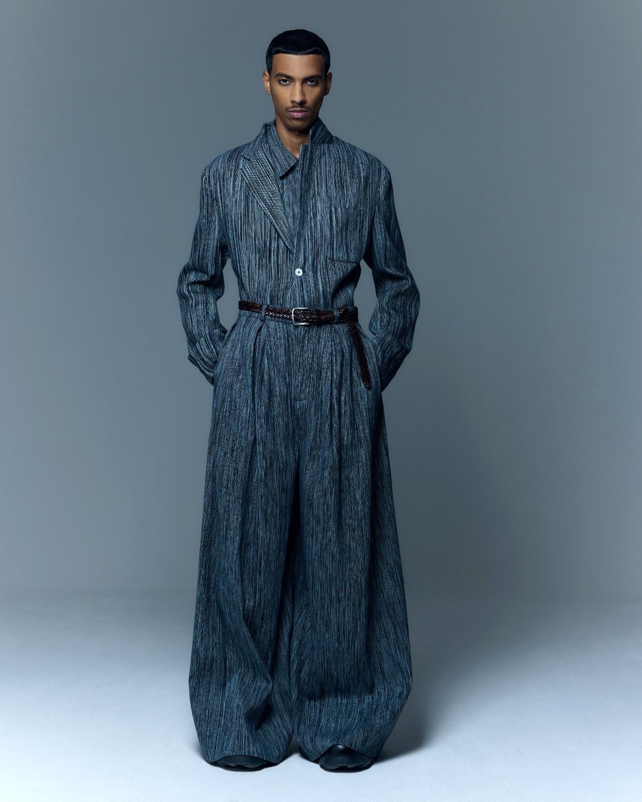 Model is wearing the Grey Chambray Blazer by Marrakshi Life, a hand-woven chambray cotton blazer with an elongated relaxed fit, notched collar and front buttons, curated in the House of Woven Stories selection.