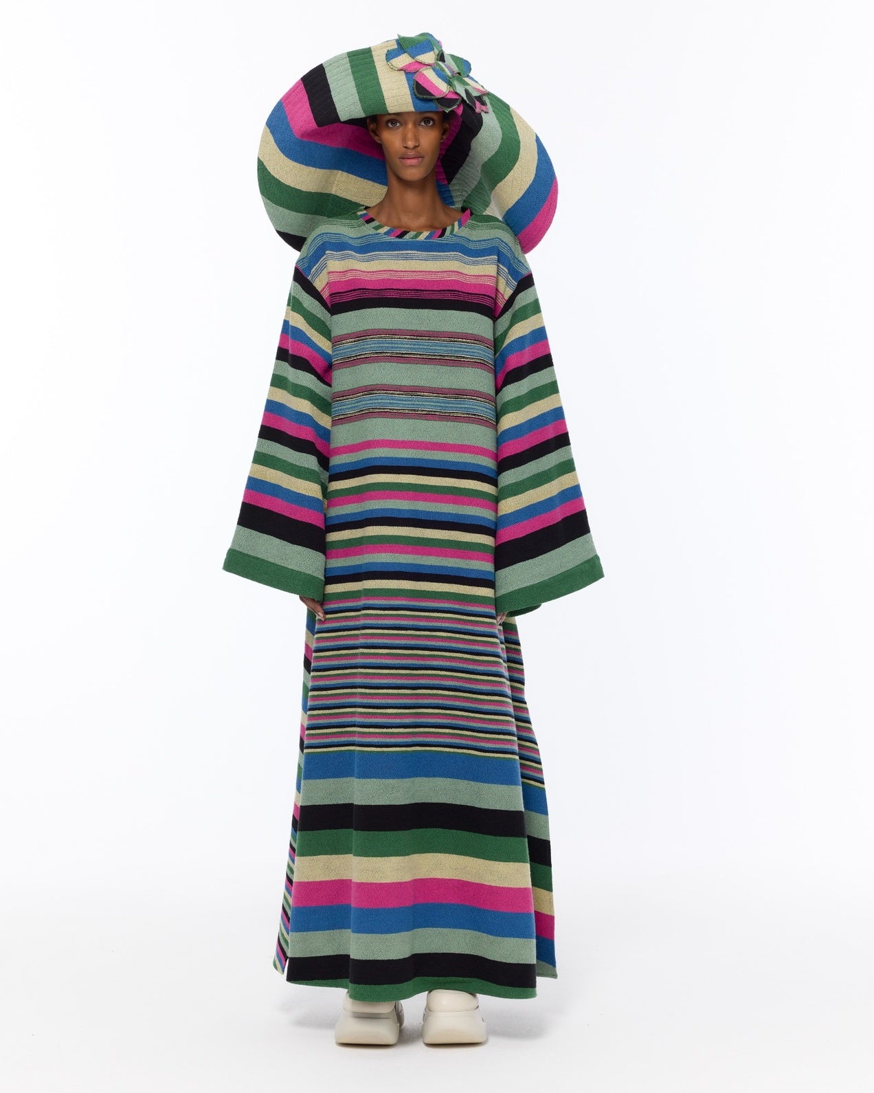 Model is wearing the Kimono Bouclé Multicolor Dress by Marrakshi Life, a hand-woven striped cotton bouclé dress with vibrant colors and flowing kimono sleeves, curated in the House of Woven Stories selection.