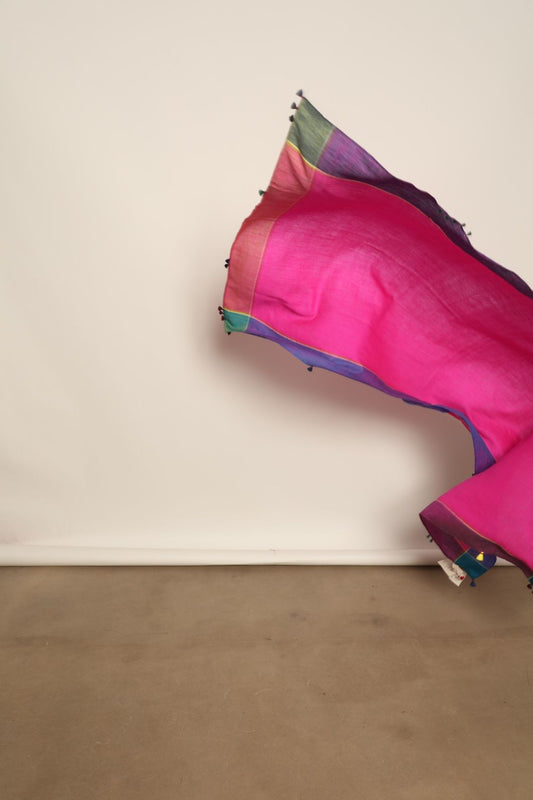 Model is wearing the Miraj 139 Cashmere Scarf by Injiri, handwoven from Himalayan cashmere with a soft pink base, teal and purple borders, and yellow accents, blending warmth, elegance, and artisanal craftsmanship.