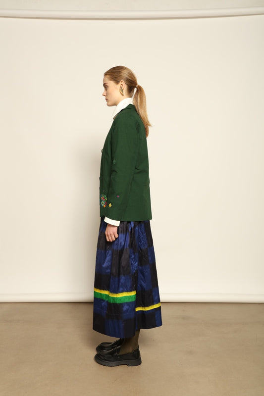 Model is wearing the Miraj 65 Cotton and Silk Jacket by Injiri, handwoven in deep green cotton and silk with geometric Jamdani motifs, blending Indian craftsmanship with contemporary elegance.