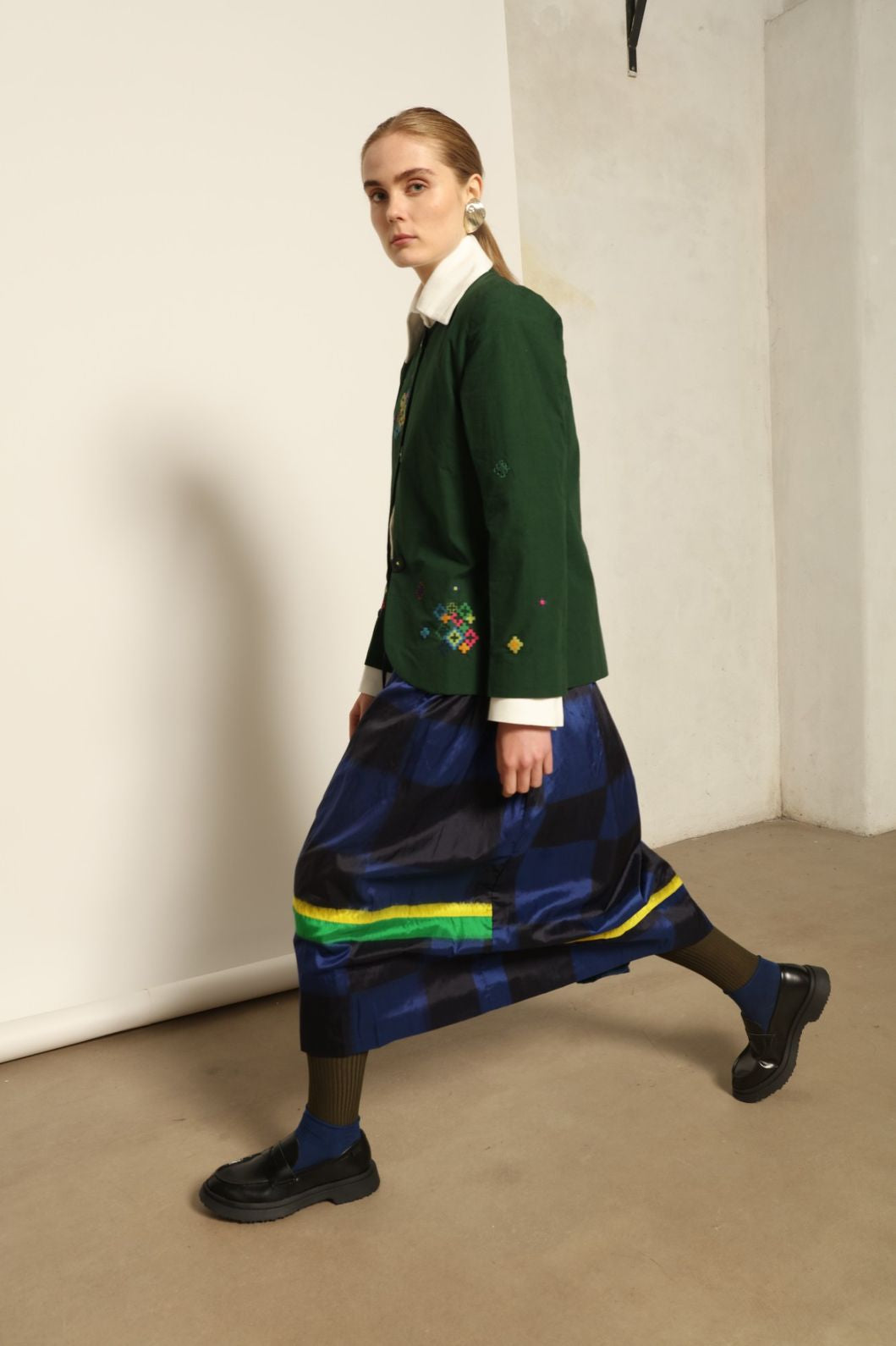 Model is wearing the Miraj 65 Cotton and Silk Jacket by Injiri, handwoven in deep green cotton and silk with geometric Jamdani motifs, blending Indian craftsmanship with contemporary elegance.