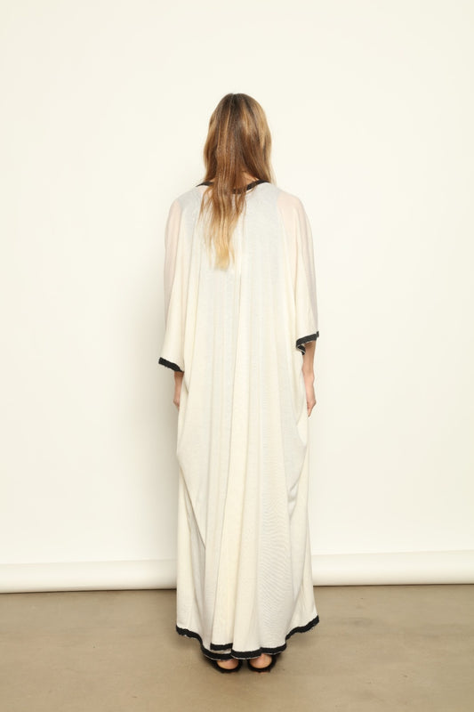 Model Nastia wearing the Natural White Long Cardigan by Mirror in the Sky, a handmade 100% cashmere long cardigan with flowing silhouette and natural undyed finish.