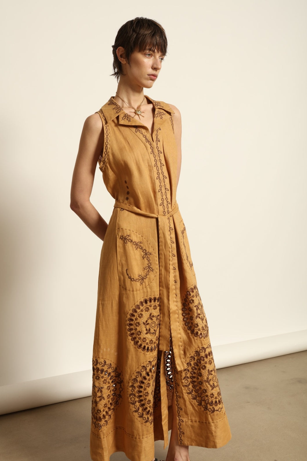 Model is wearing the My Sleeping Gypsy Sarah Long Sleeveless Dress "Merezhivo," handcrafted with Richelieu technique and 24-carat gilded bead detailing, from the House of Nomad Stories selection.