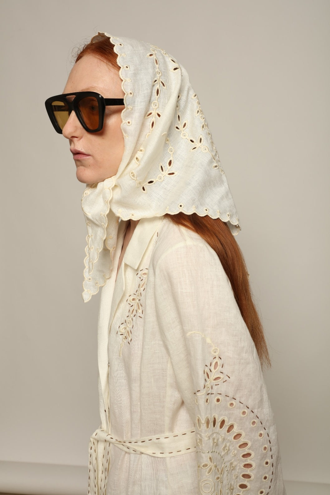 Model is wearing the My Sleeping Gypsy Slavia Head Scarf, handcrafted from linen with intricate embroidery inspired by Slavic heritage, from the House of Nomad Stories selection.