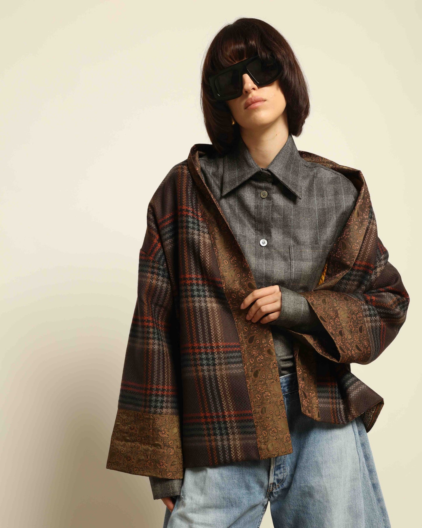 Model is wearing the Obidi Checked Kantha Jacket in wool and silk, with a silk collar and unique printed silk lining, a one-of-a-kind artisanal piece. Part of House of Woven Stories selection.