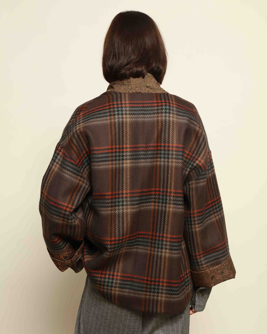 Model is wearing the Obidi Checked Kantha Jacket in wool and silk, with a silk collar and unique printed silk lining, a one-of-a-kind artisanal piece. Part of House of Woven Stories selection.