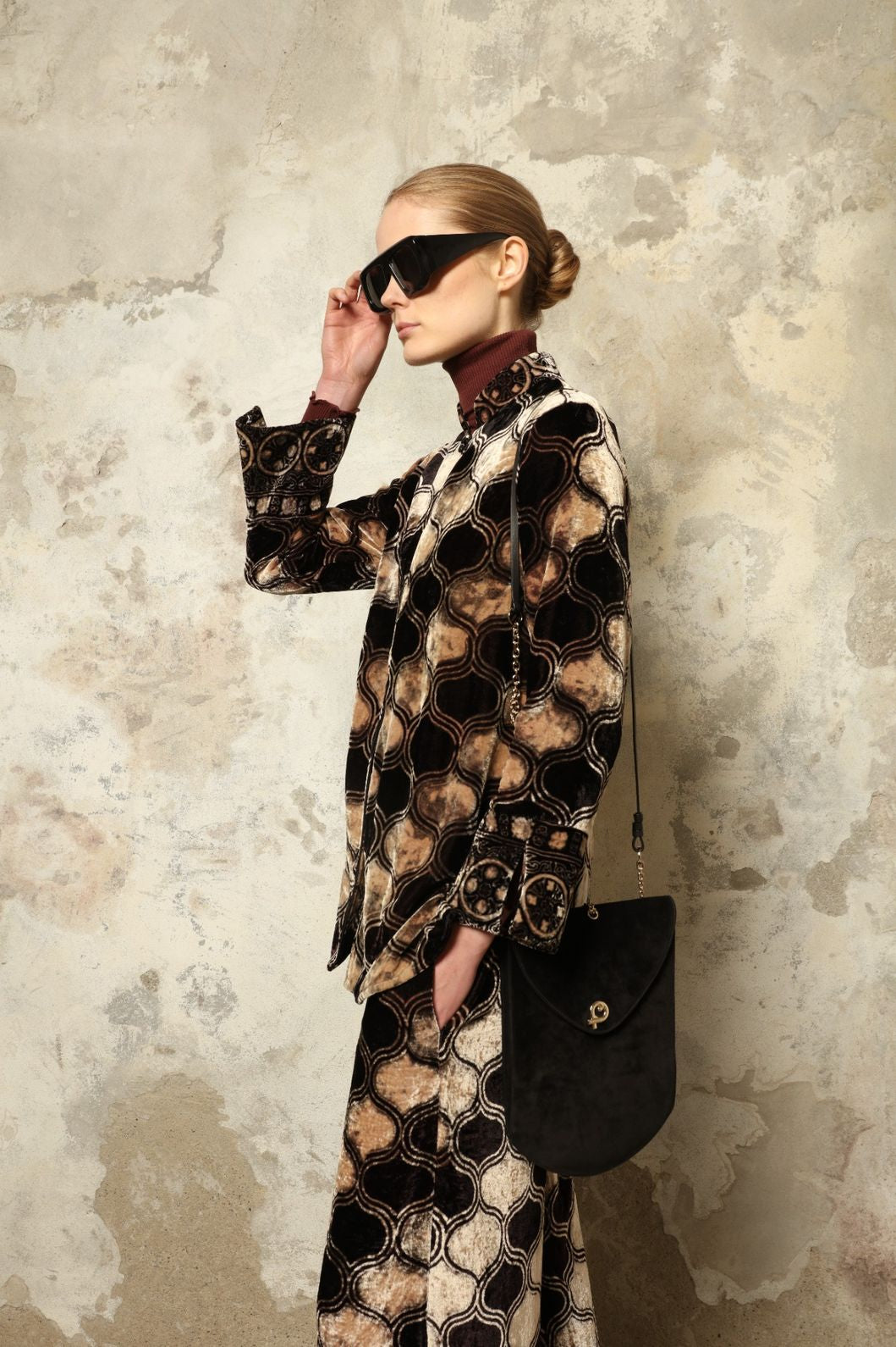 Model is wearing The Obsidian Cleo Jacket by Obidi, crafted from luxurious velvet with a structured yet fluid silhouette, blending contemporary design with traditional craftsmanship.