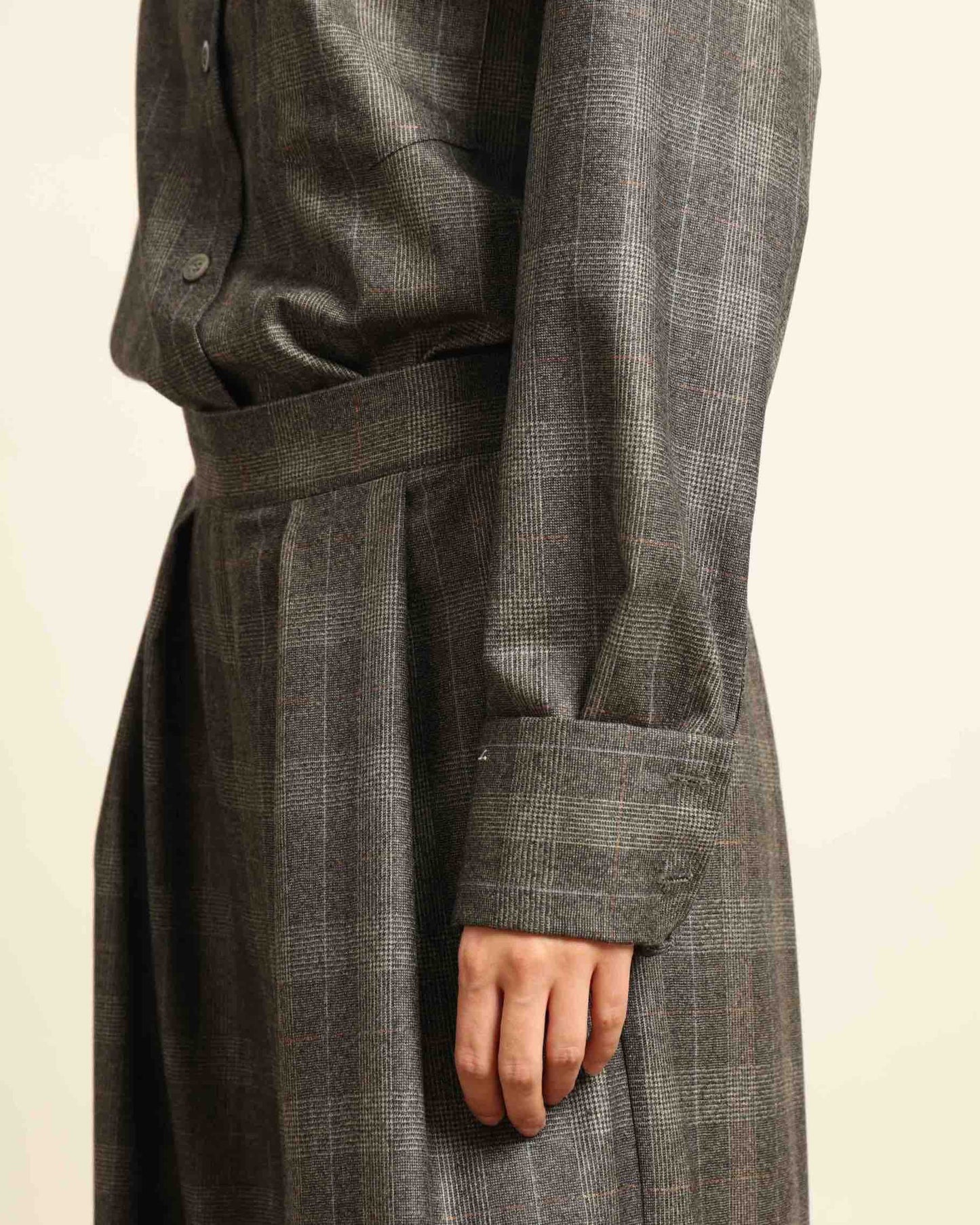 Model is wearing the Parigi Grey Check Trousers by House of Woven Stories, featuring a refined grey check pattern and a tailored silhouette, handcrafted in Piedmont, Italy.