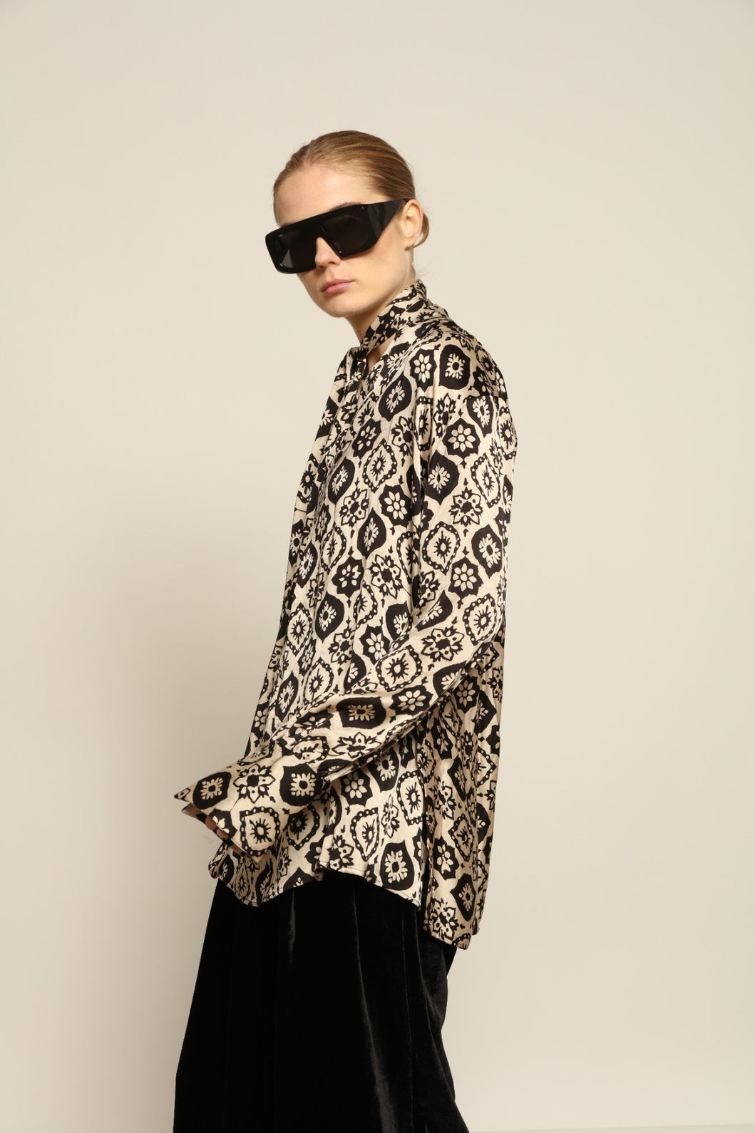 Model is wearing the Rose Silk Sutra Shirt by Obidi, crafted from pure silk with a soft, lightweight fabric and relaxed silhouette, combining timeless craftsmanship with modern style.