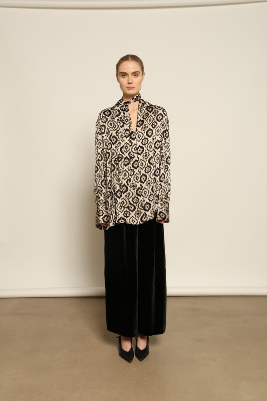 Model is wearing the Rose Silk Sutra Shirt by Obidi, crafted from pure silk with a soft, lightweight fabric and relaxed silhouette, combining timeless craftsmanship with modern style.