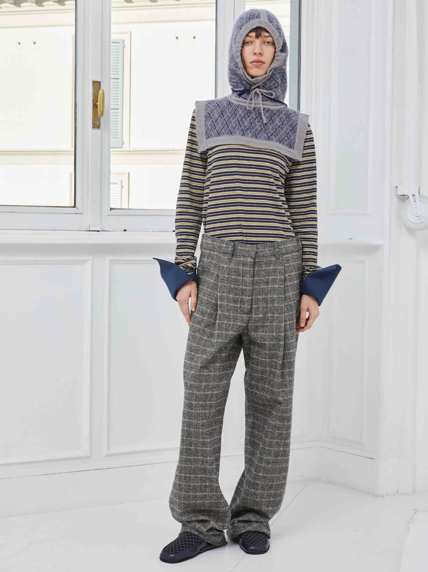 Model is wearing the Sally Cotton Check Pant by Maison Jejia, part of the House of Woven Stories selection, featuring a straight-leg fit, subtle check pattern, front pleats, belt loops, and side pockets.
