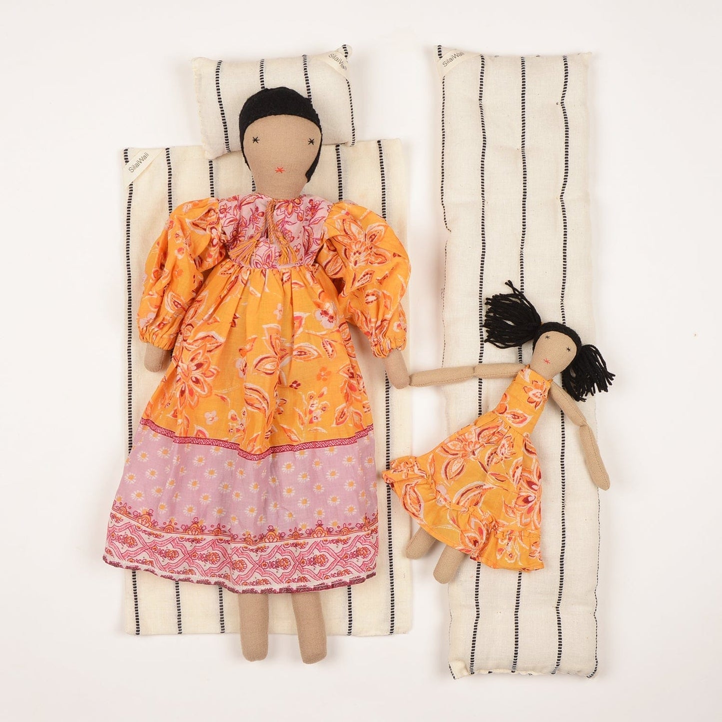 Handcrafted cloth dolls Diya and Mini by SilaiWali, mother and daughter set in traditional dresses, made from upcycled fabric. Available at House of Woven Stories.