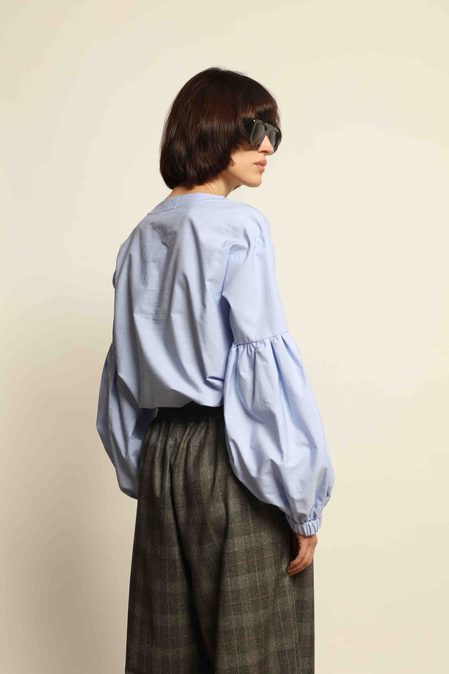 Model wearing the Sky Blue Lulu Pure Poplin Cotton Blouse with balloon sleeves by House of Woven Stories, crafted in Italy.