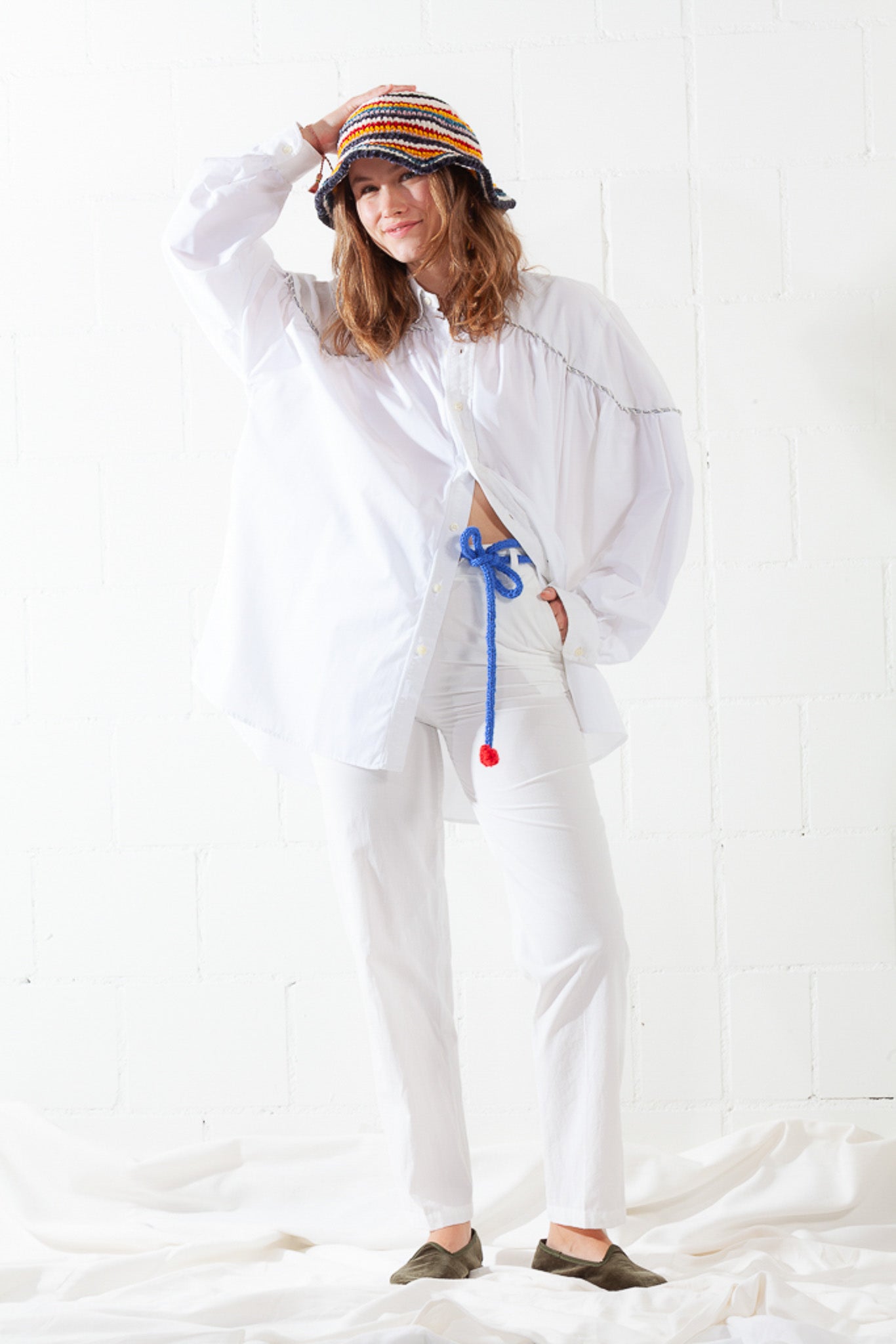 Model is wearing the Talla Latte High-Waist Cotton Trousers by Balia 8.22, featuring a chic latte hue, front button closure, belt loops, and a tailored fit for modern elegance and everyday comfort.