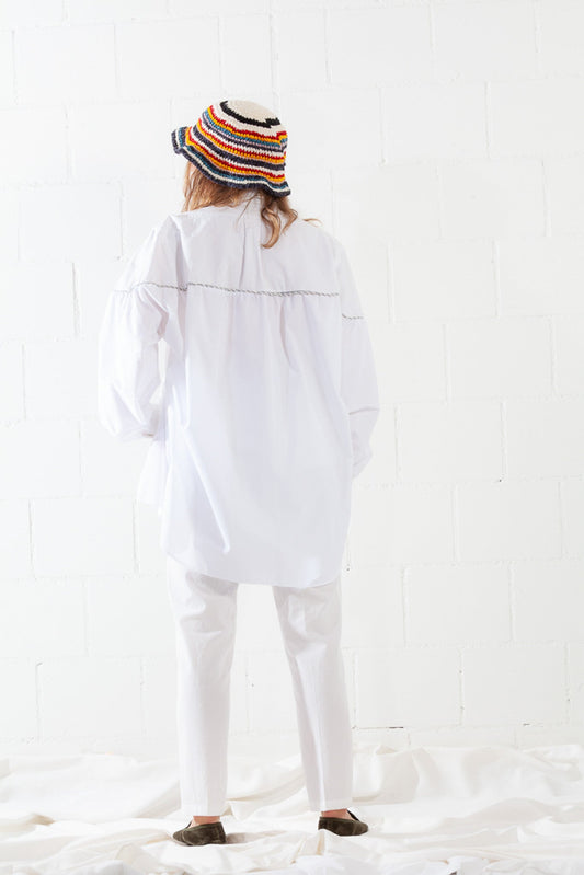 Model is wearing the Talla Latte High-Waist Cotton Trousers by Balia 8.22, featuring a chic latte hue, front button closure, belt loops, and a tailored fit for modern elegance and everyday comfort.