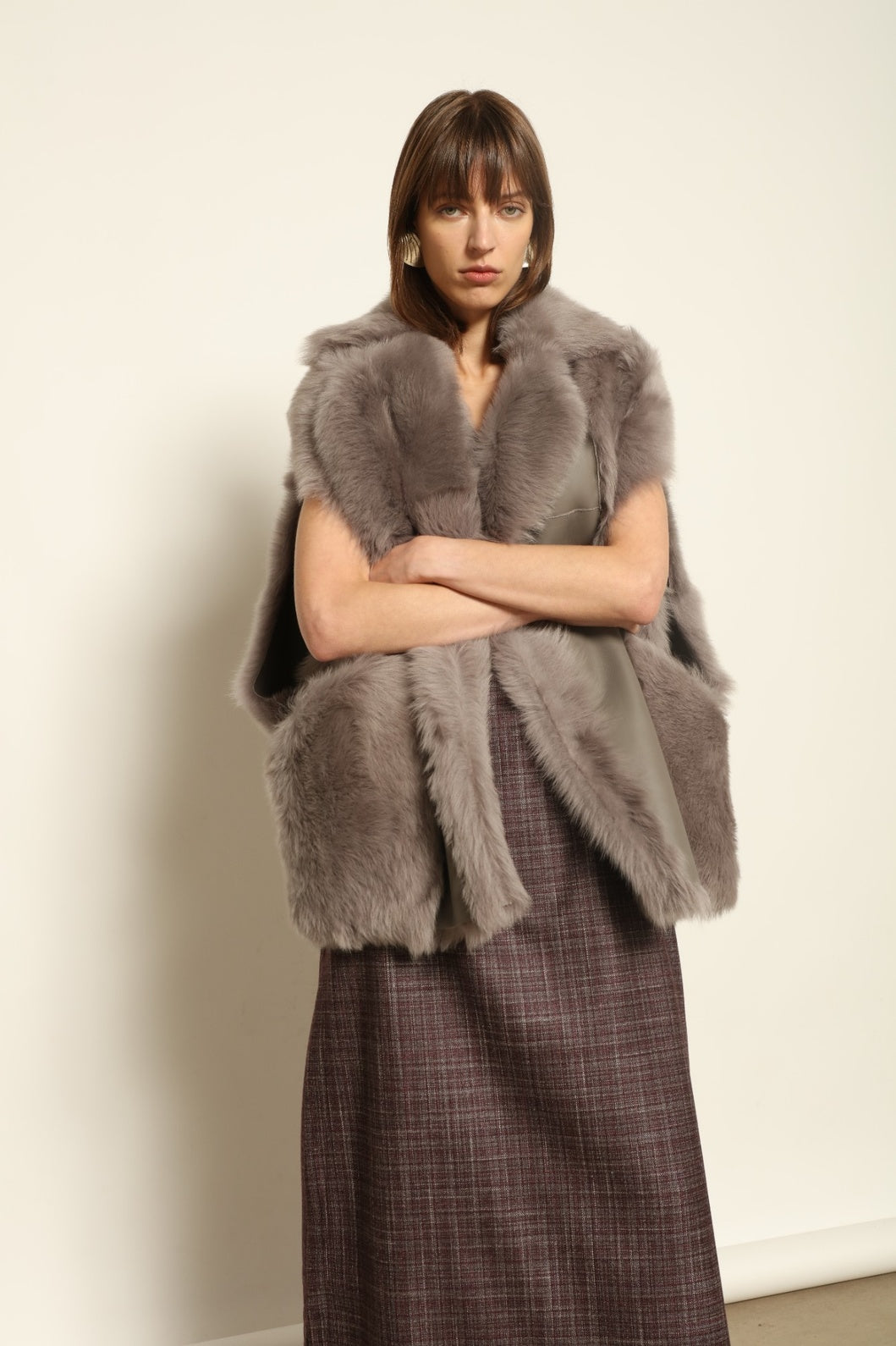 Model is wearing the Toscana Storm Shearling Vest by Blancha, crafted from 100% Toscana sheepskin in the Storm shade with soft, luxurious texture and Italian craftsmanship.