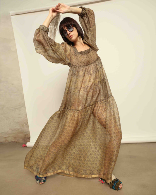 Model is wearing vintage-inspired maxi dress in lightweight 100% silk chiffon with square neckline, voluminous sleeves, and delicate all-over print. Part of House of Woven Stories selection.