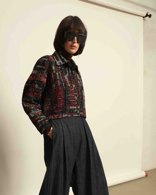 Model is wearing the Rewoven Hand-loomed Bomber by Paiwand, an upcycled unisex jacket crafted from handwoven organic cotton off-cuts with unique color and design variations.