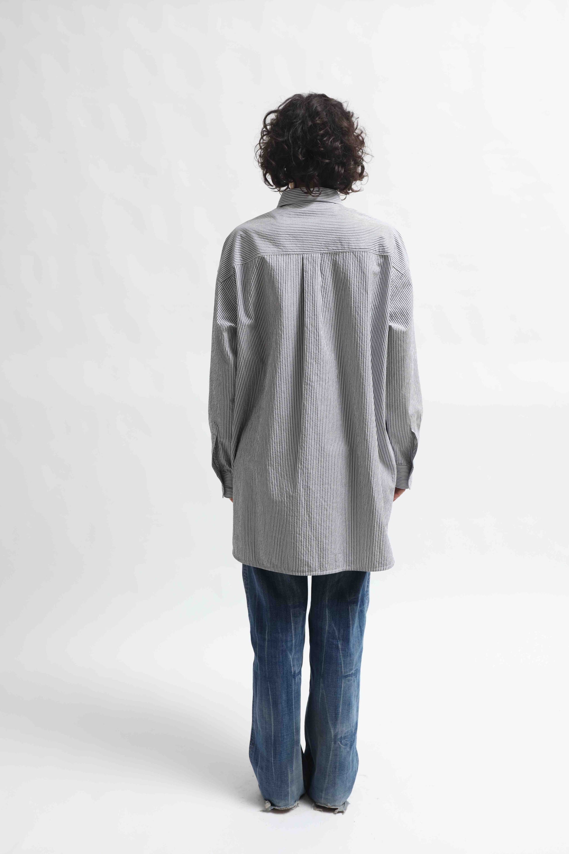 Crisp 100% organic cotton shirt with classic collar and marine blue and white stripes, handcrafted by House of Woven Stories in Italy’s Piedmont region, featuring a soft paper-touch finish and relaxed fit for versatile, refined style.