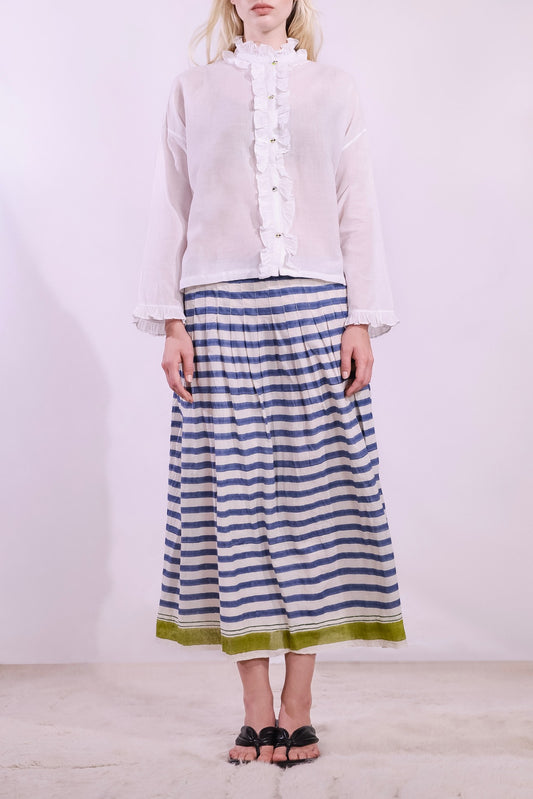Model wearing a long pleated pure cotton skirt with indigo and off-white stripes, elastic waistband, and pistachio hem. Handcrafted in India by Injiri.