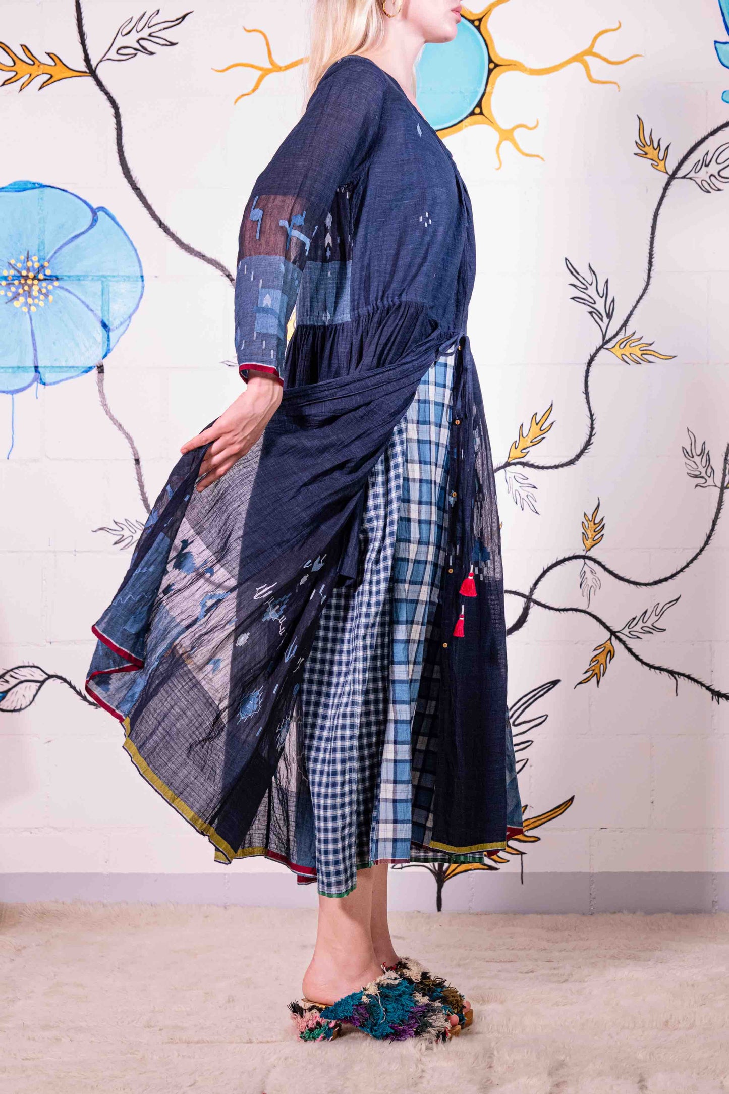 Model wearing pure cotton dress by Injiri – navy blue handloomed summer dress with jamdani weaving, contrast trim, long sleeves, and adjustable drawstring waist. Made from 100% organic cotton and handcrafted in India.