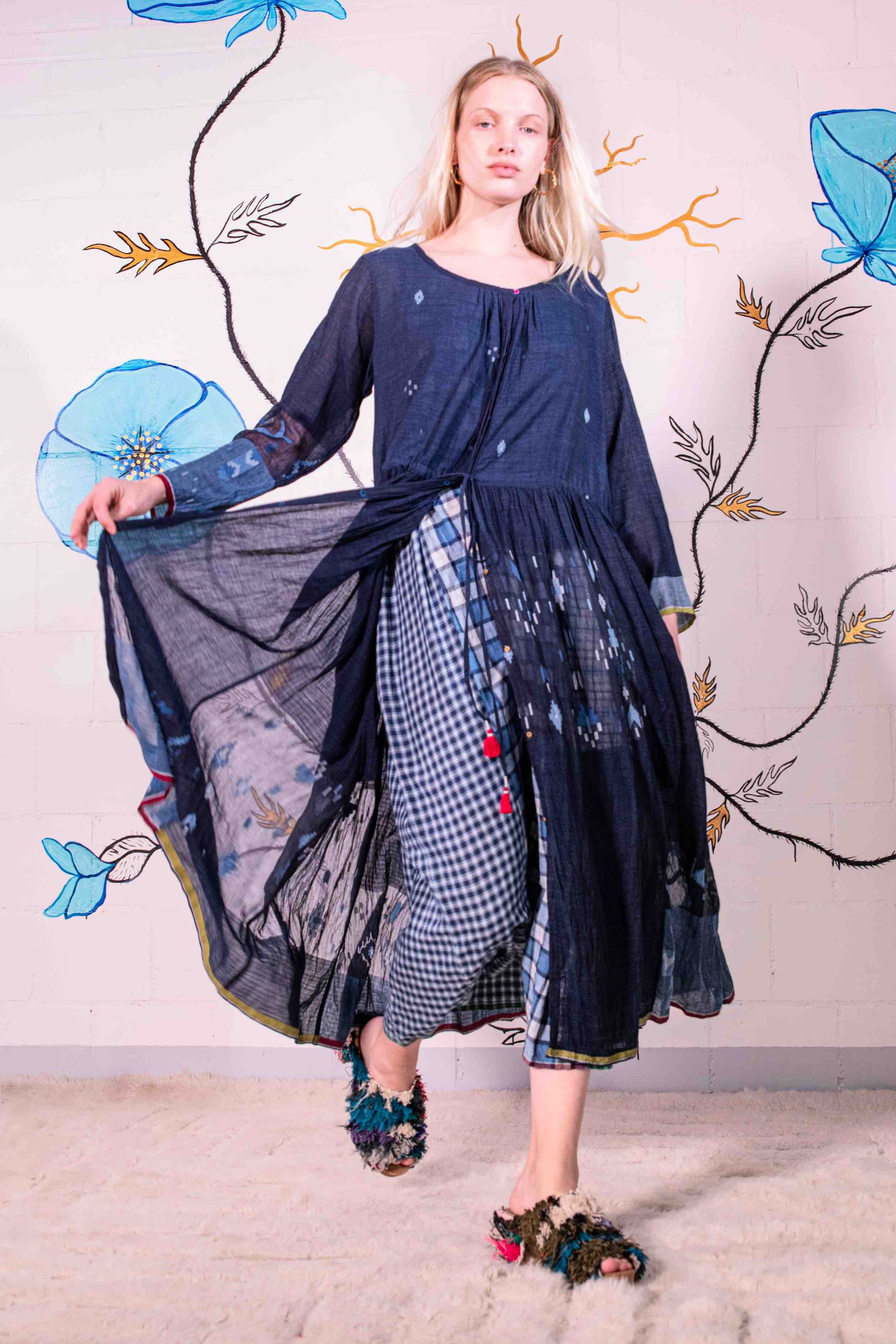 Model wearing pure cotton dress by Injiri – navy blue handloomed summer dress with jamdani weaving, contrast trim, long sleeves, and adjustable drawstring waist. Made from 100% organic cotton and handcrafted in India.