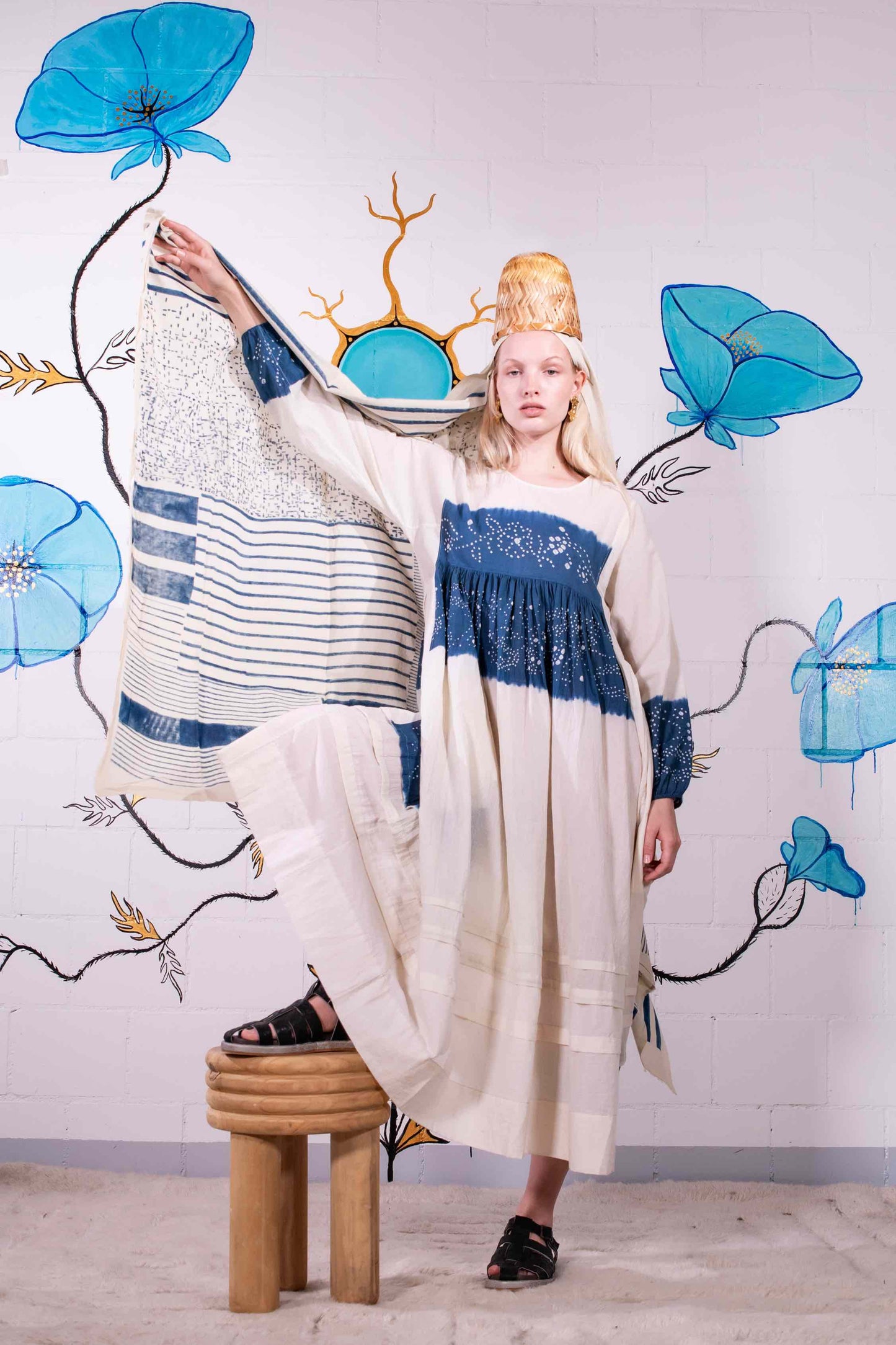 Model wearing pure cotton maxi dress by Injiri – long-sleeve off-white handloomed dress with indigo tie-dye and shibori print, side pockets, and fluid silhouette. Handcrafted in India using organic cotton.