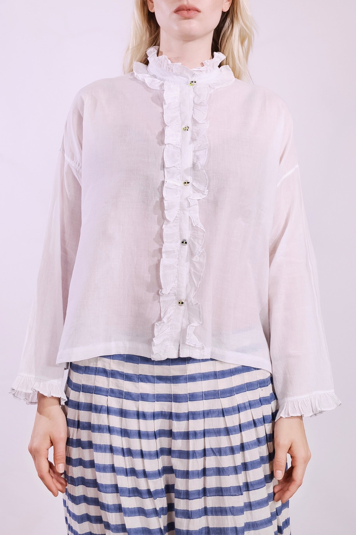 White pure cotton shirt by Injiri with cobalt ruffle stitching and yellow buttons, handmade and sustainable. Available at House of Woven Stories.