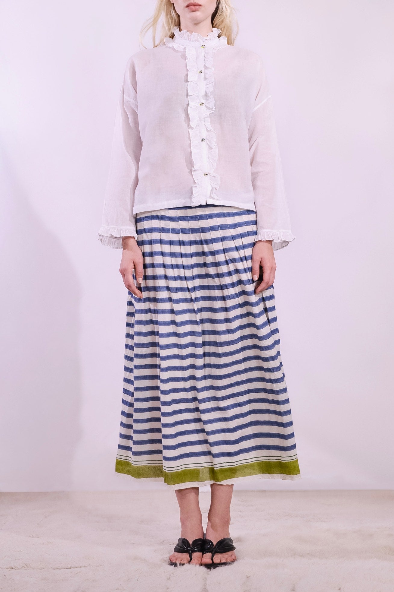 White pure cotton shirt by Injiri with cobalt ruffle stitching and yellow buttons, handmade and sustainable. Available at House of Woven Stories.