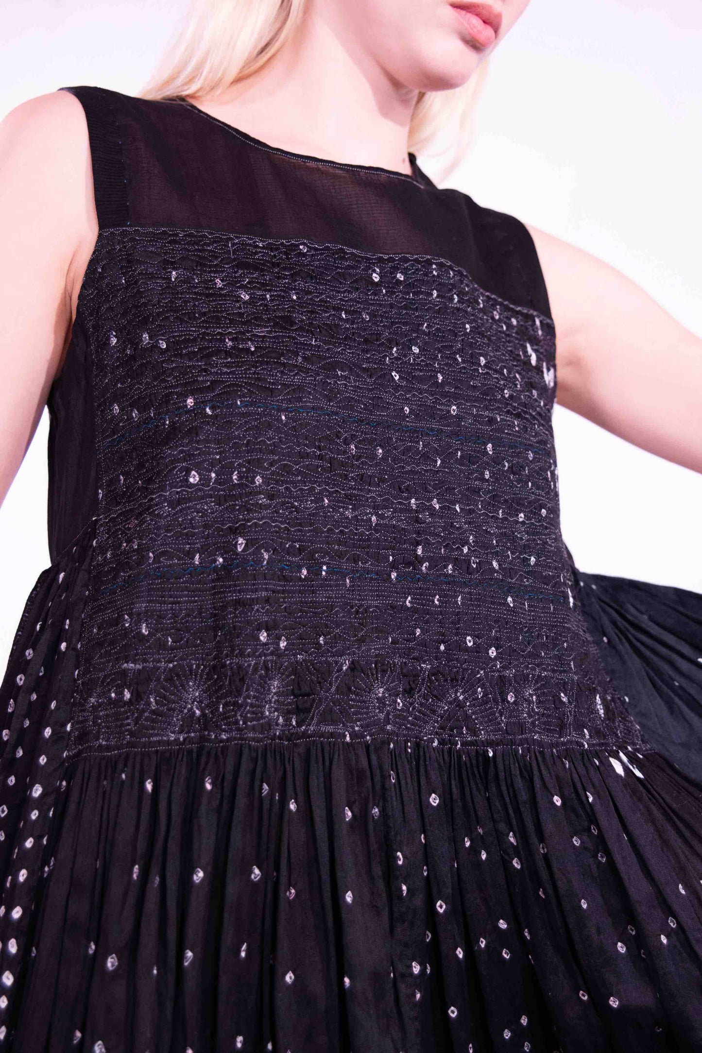 Model is wearing a long, flowing silk-cotton blend dress in black with navy and white accents. Features a softly flared skirt. Handmade in India with traditional techniques by Injiri.